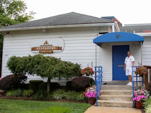 caption: Commodore Benny McCottry stands outside the entrance of the Seafarers Yacht Club of Annapolis in Annapolis, Md. It was founded more than 60 years ago by a handful of Black boaters.