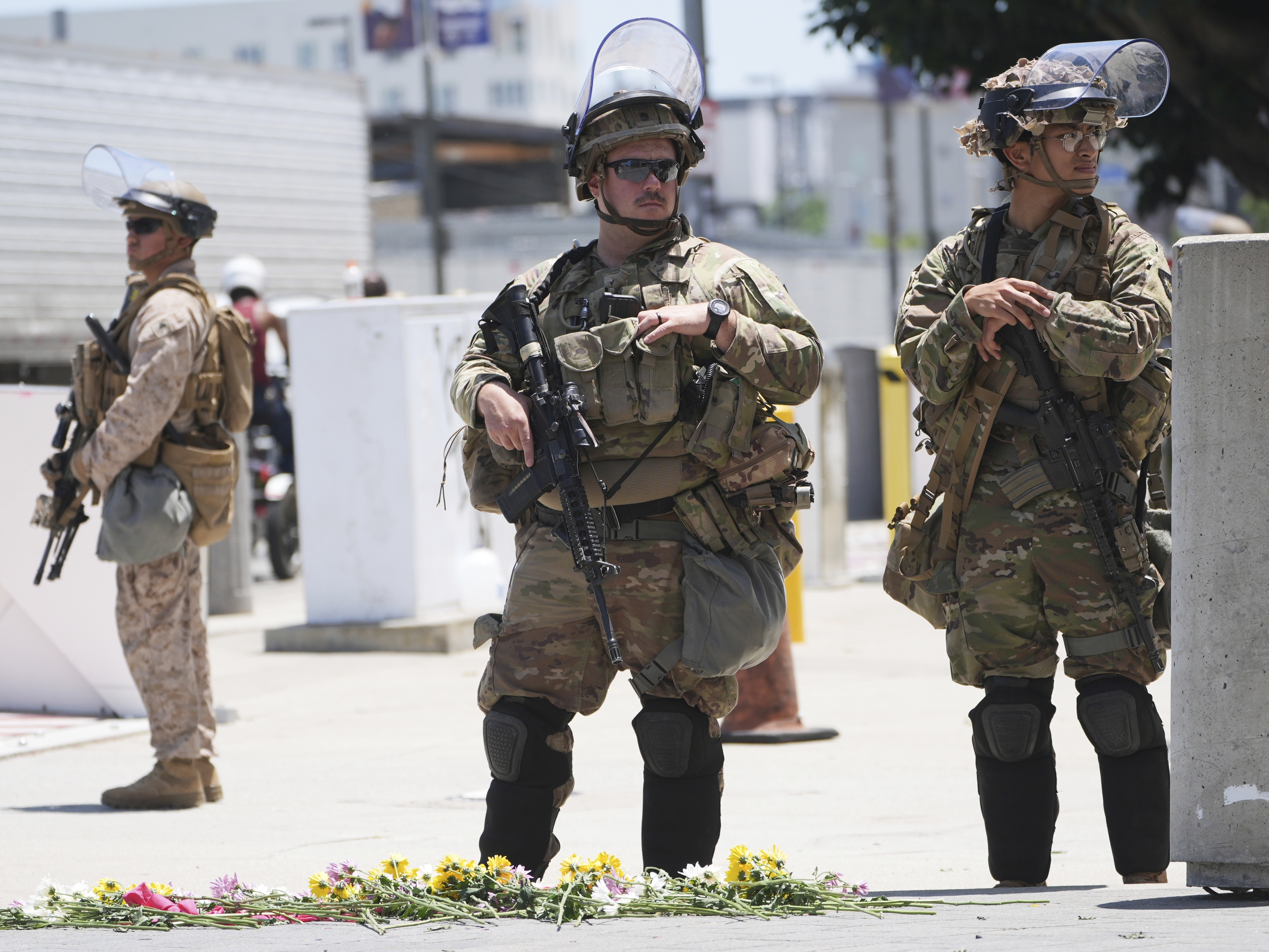 caption: Members of the California National Guard and U.S. Marines guard a federal building in June.