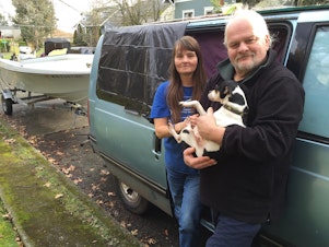 caption: Terry, Suzette and their dog Lulu live in a van in Ballard. They store their belongings in an SUV, and they tow a boat.