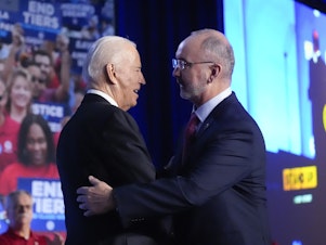 caption: President Biden is greeted by Shawn Fain, President of the United Auto Workers. The union endorsed Biden's reelection bid on Wednesday.