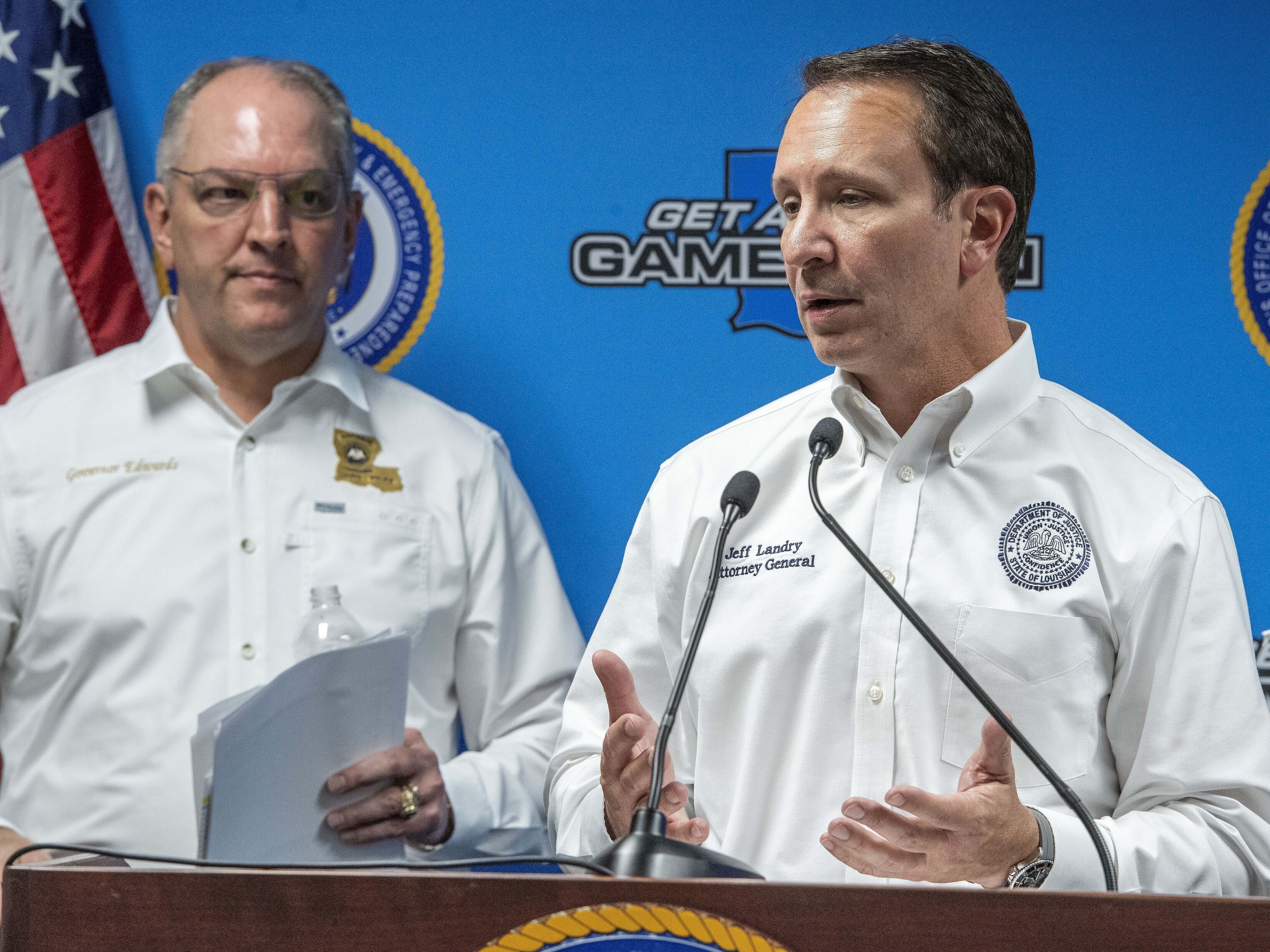 caption: Louisiana Attorney General Jeff Landry, right, pictured with Gov. John Bel Edwards in 2020, said the court action halts President Biden's administration from "moving forward with his unlawful overreach."