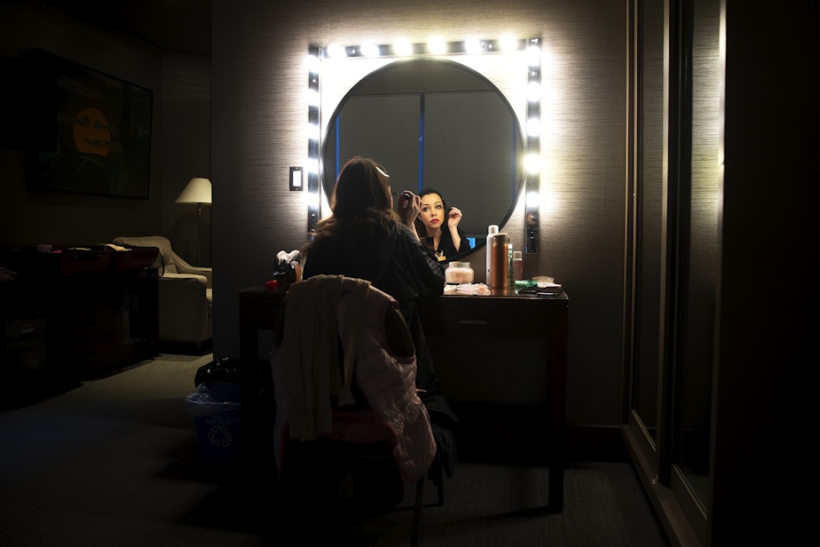 caption: Kateryna Kukhar, principal dancer with the Grand Kyiv Ballet, applies makeup in a dressing room before performing as Cinderella in Snow White, on Wednesday, December 20, 2023, at the Paramount Theatre in Seattle. 