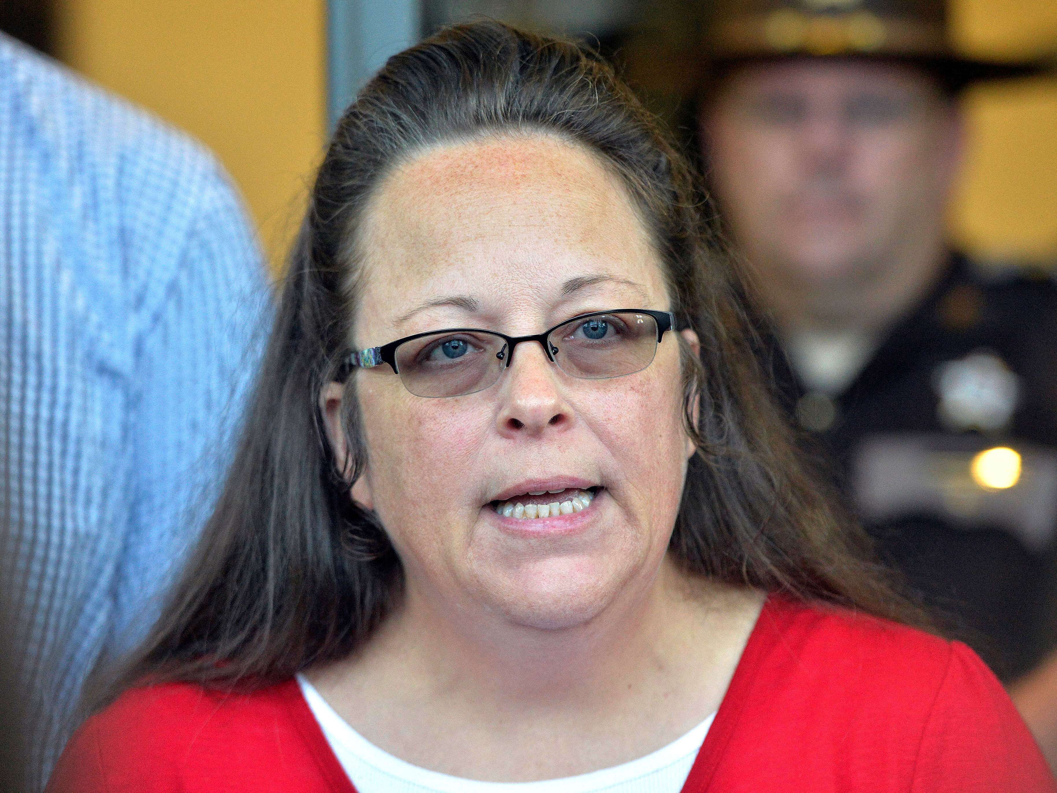 caption: Rowan County Clerk Kim Davis makes a statement to the media at the front door of the Rowan County Judicial Center in Morehead, Ky., in September 2015.