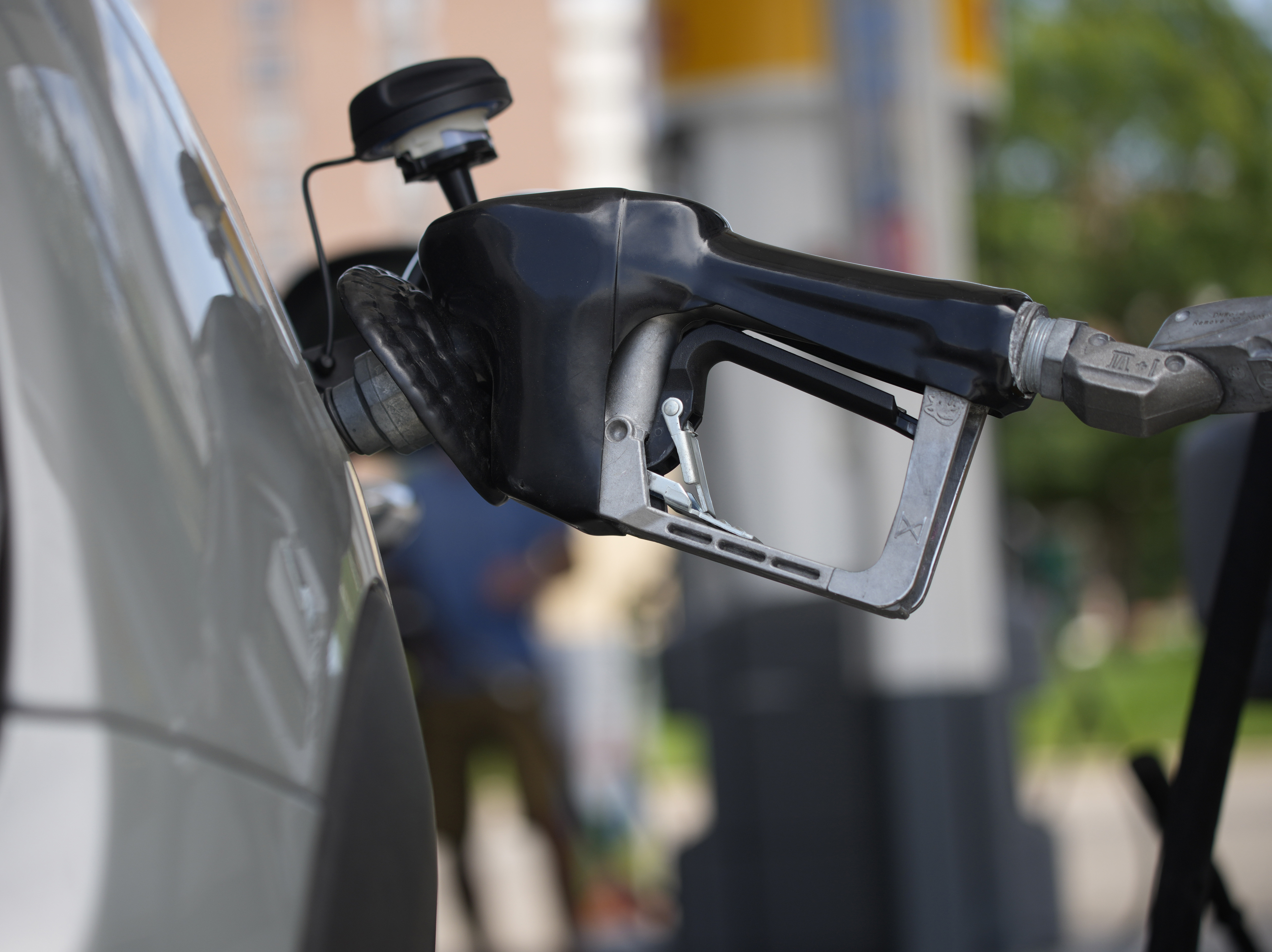 caption: Motorists fill up their vehicles at a Shell station on July 22 in Denver. Phasing out the sale of gas-powered cars once seemed laughable. It's now inching closer to reality.
