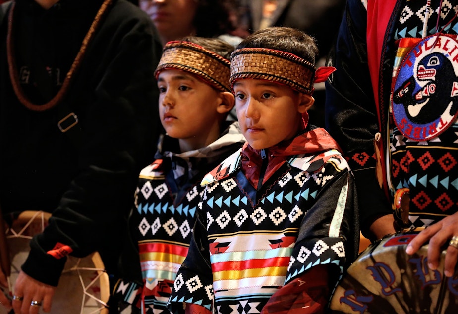 caption: Josh Fryberg Jr (9) center, and  Daniel Fryberg (8), left center, during the opening ceremony at the Tulalip Gathering Hall on Sunday in Tulalip.