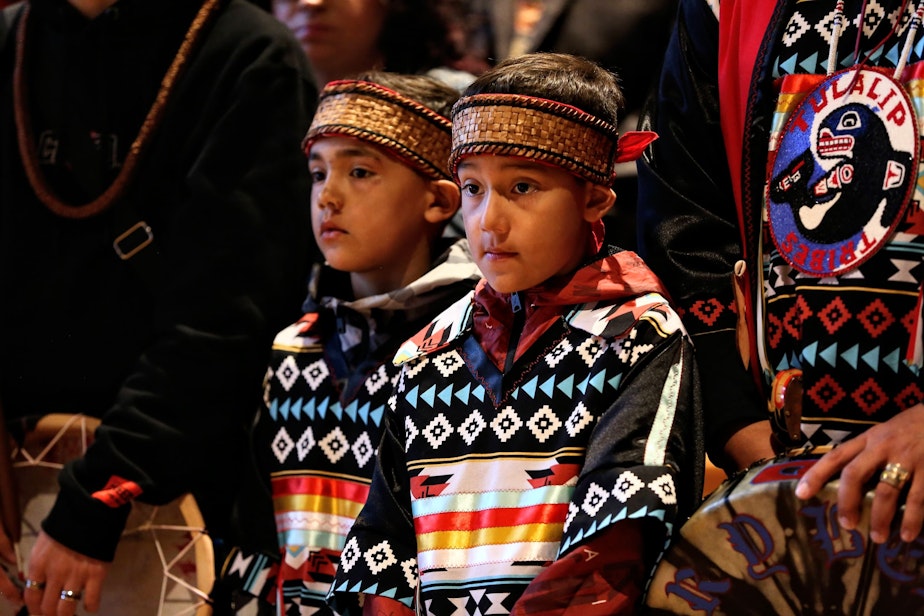 caption: Josh Fryberg Jr (9) center, and  Daniel Fryberg (8), left center, during the opening ceremony at the Tulalip Gathering Hall on Sunday in Tulalip.