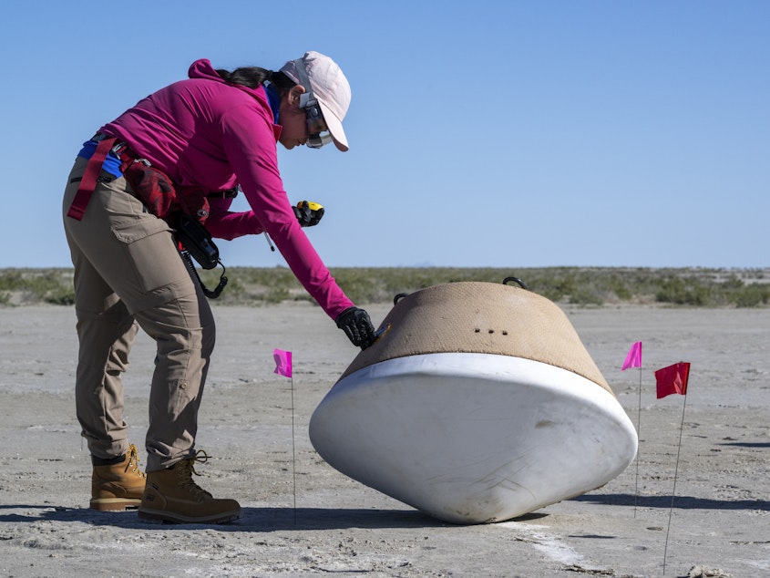 caption: Recovery teams participate in field rehearsals in preparation for the retrieval of the sample return capsule from NASA's OSIRIS-REx mission in August 2023 in Utah.