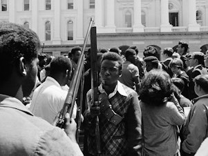 caption: Armed members of the Black Panther Party leave the Capitol in Sacramento May 2, 1967. The Panthers entered the Capitol fully armed and said they were protesting a bill before the Legislature restricting the carrying of arms in public.