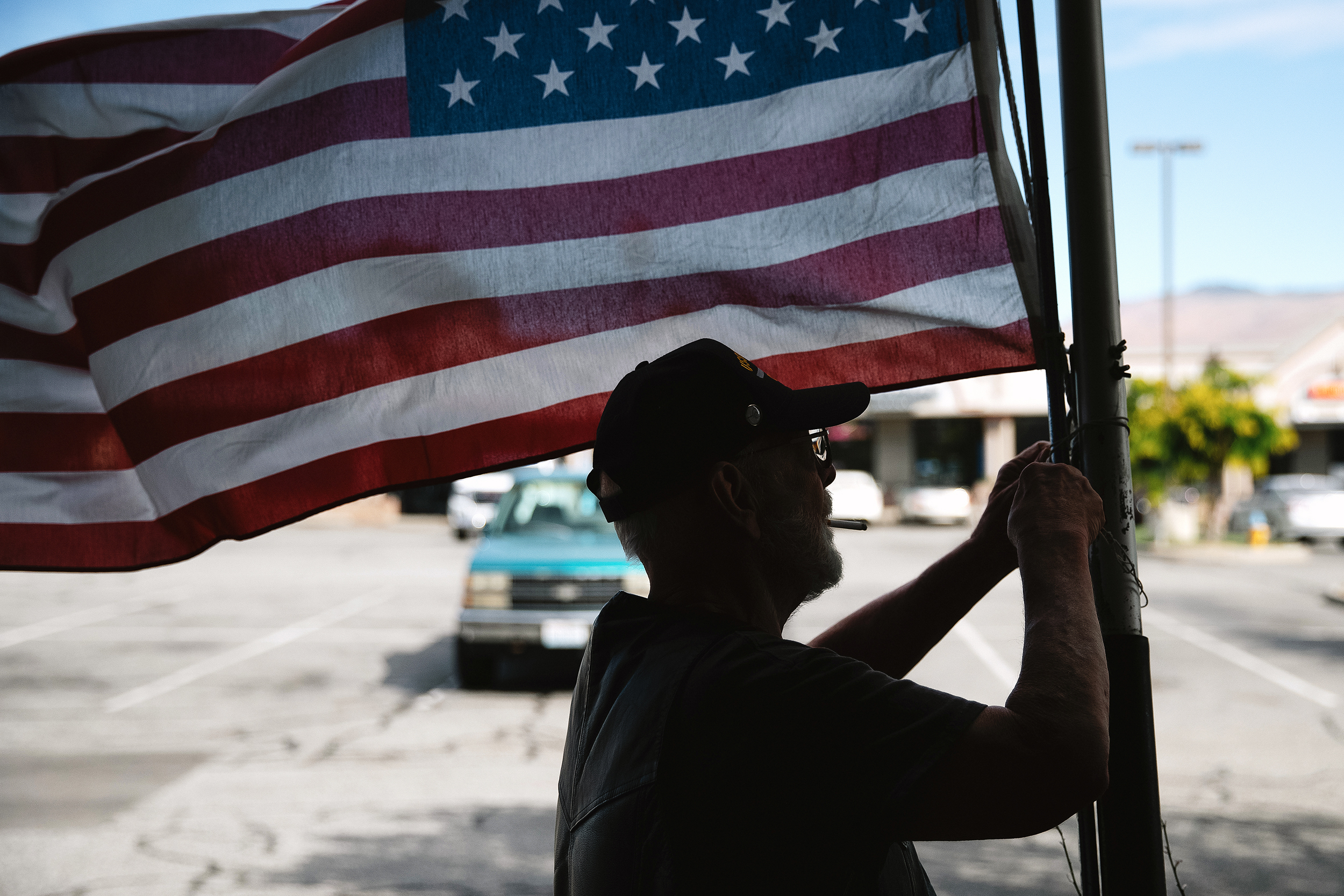 caption: Chipper Lee, a 71-year-old Vietnam veteran adjusts a makeshift flagpole after the American flag outside of North Central Washington Vets Serving Vets location, ‘The Bunker,’ was cut down the night before, on Thursday, July 10, 2025, in Wenatchee. The veteran community in north-central Washington is asking for increased mental health services — to help prevent the next tragedy.