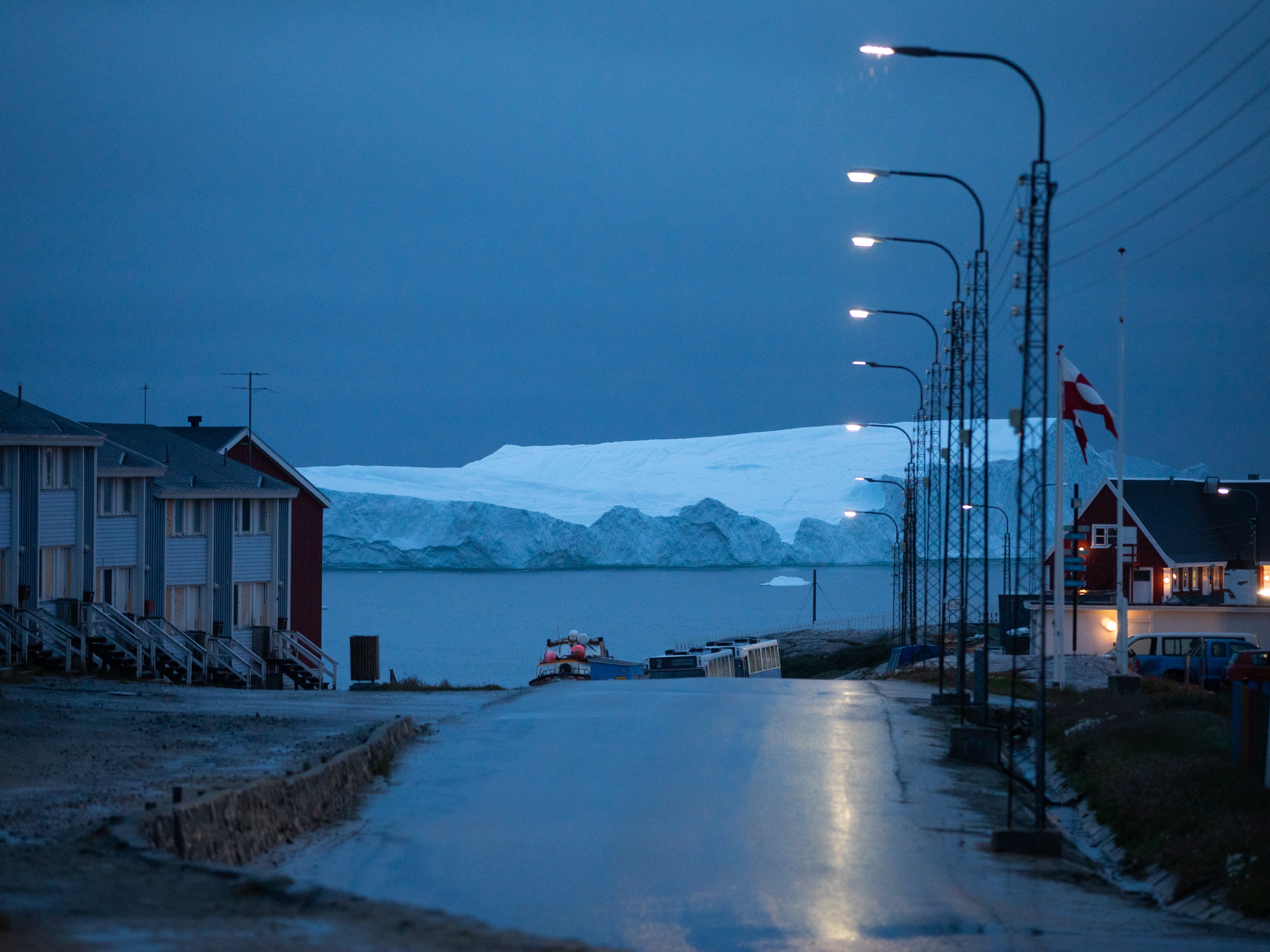 caption: An iceberg floats off the coast of Illulisat, Greenland. Ice sheets in Greenland and Antarctica are melting rapidly, and the risks of drastic melting increase  as the Earth heats up. The melting of Greenland's ice sheet is the second-largest contributor to global sea-level rise. (The largest contributor is water expanding as it warms.)