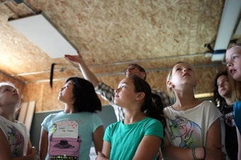 caption: Students examine a SEED portable classroom recently installed at the Perkins School in North Seattle.