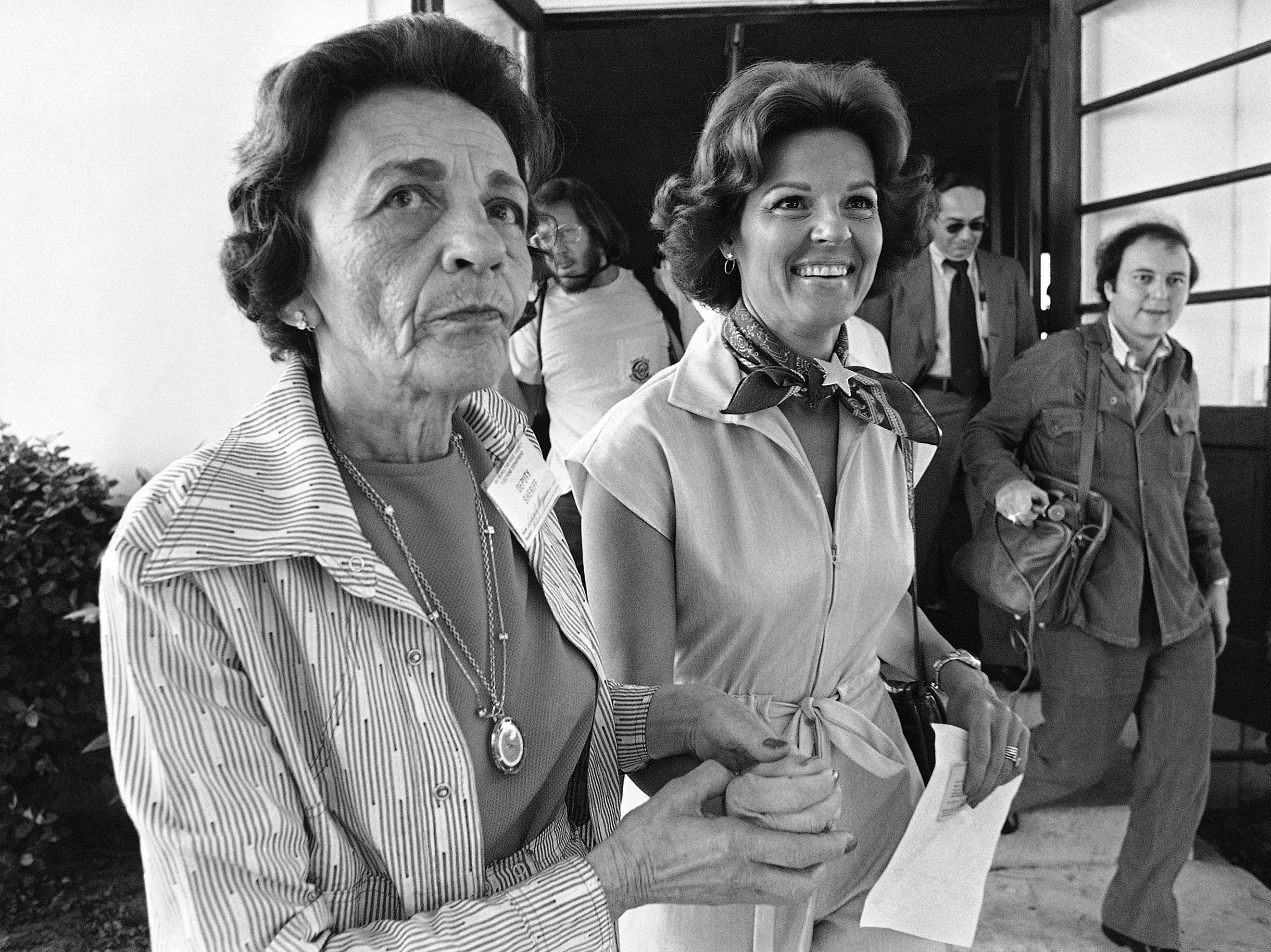 caption: Singer Anita Bryant is led to the voting booth at her Miami Beach polling place by volunteer Leah Dezen in 1977. Bryant was the leader of the opposition group "Save Our Children" whose members pushed for the repeal of a gay rights ordinance in Miami-Dade County.