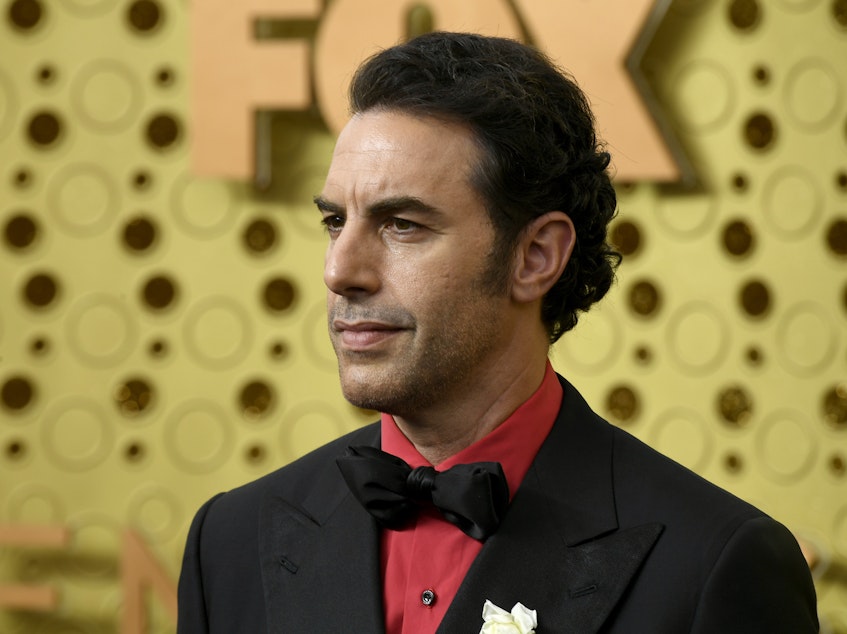 caption: Sacha Baron Cohen, pictured at the Emmy Awards in 2019, is suspected of being behind a prank on a far-right group.