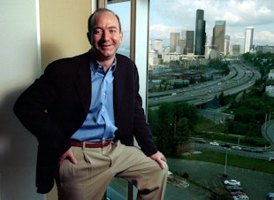 caption: FILE: Jeff Bezos, founder and CEO of Amazon.com, is shown at the online retail company's then-offices overlooking the Seattle skyline on May 2, 2001. The original caption reads, 'Despite company layoffs and a bruising stock plunge, Bezos says he believes in Amazon more than ever.'