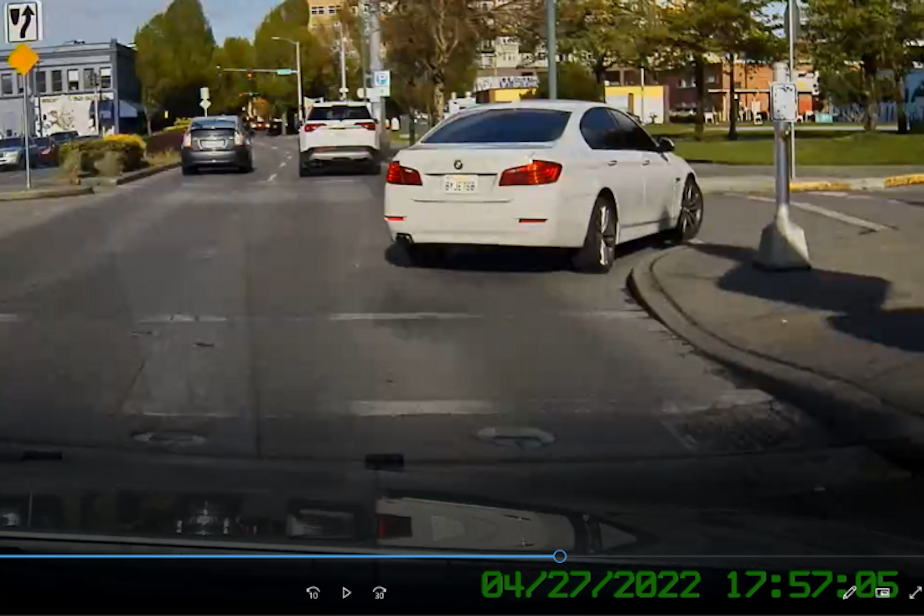 caption: This Washington State Patrol dashcam video from April 2022 captures a white BMW with a stolen license plate failing to stop for a trooper. in Olympia The driver took off at a high rate of speed, but the trooper didn't give chase. 