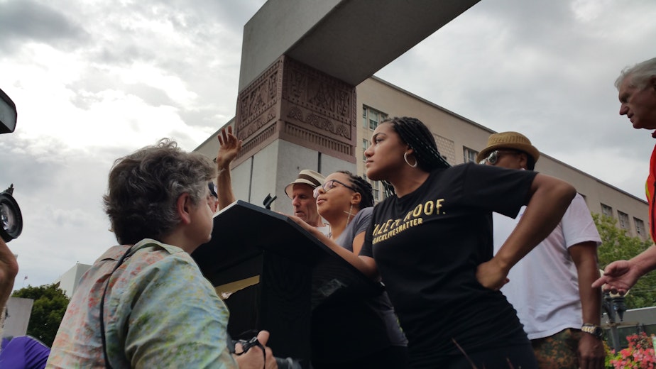 caption: Activists from the Seattle chapter of Black Lives Matter took over the stage at a rally for Vermont Sen. Bernie Sanders on Sat., Aug 8, 2015. They called for four minutes of silence, and Sanders left the stage to greet those who had come to see him. 