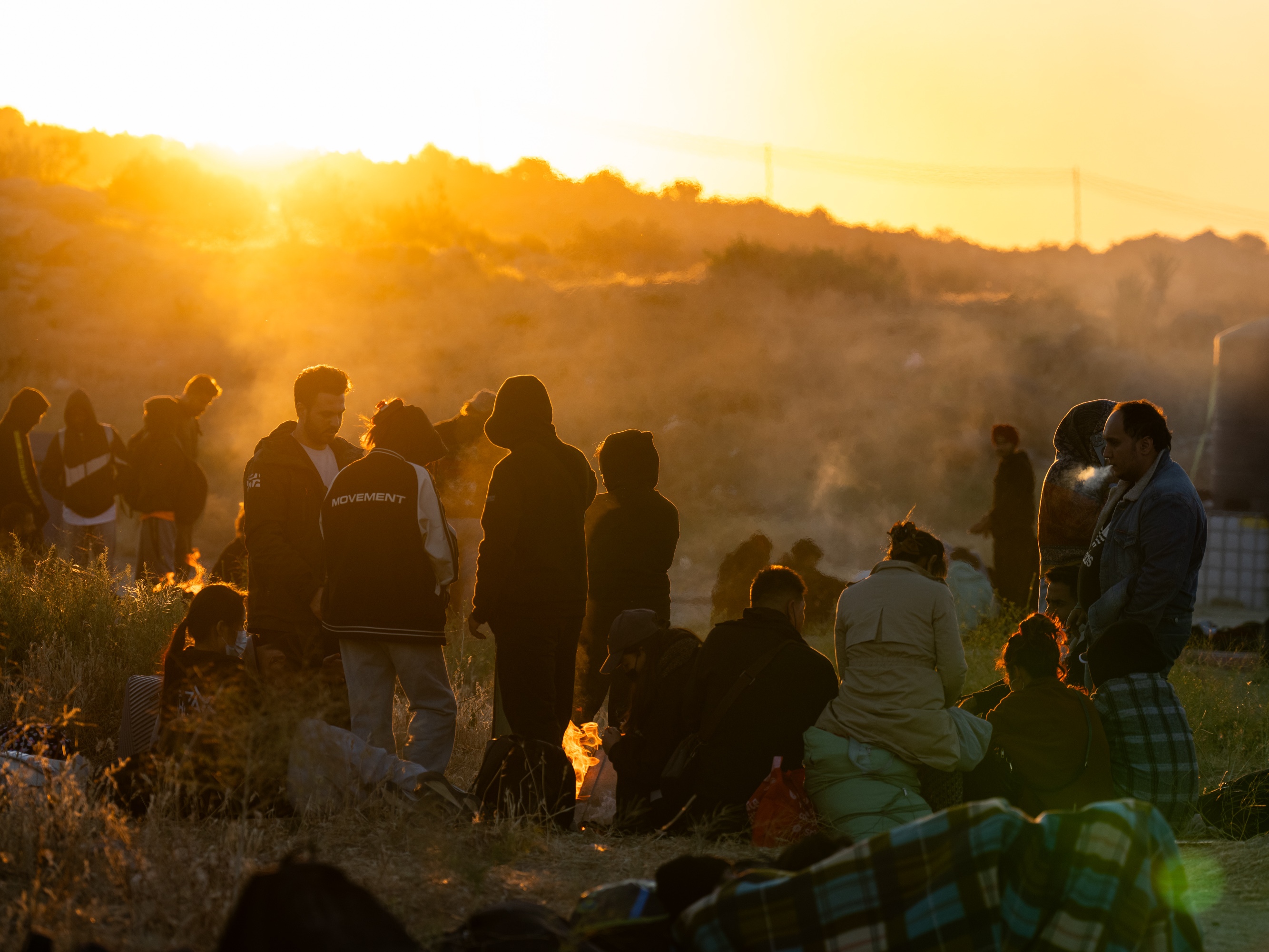 caption: Migrants gather at an informal camp near Jacumba Hot Springs, California, on June 14, 2024. Once they cross the border into the U.S., they wait to be processed by U.S. Border Patrol, in their hope to claim asylum.