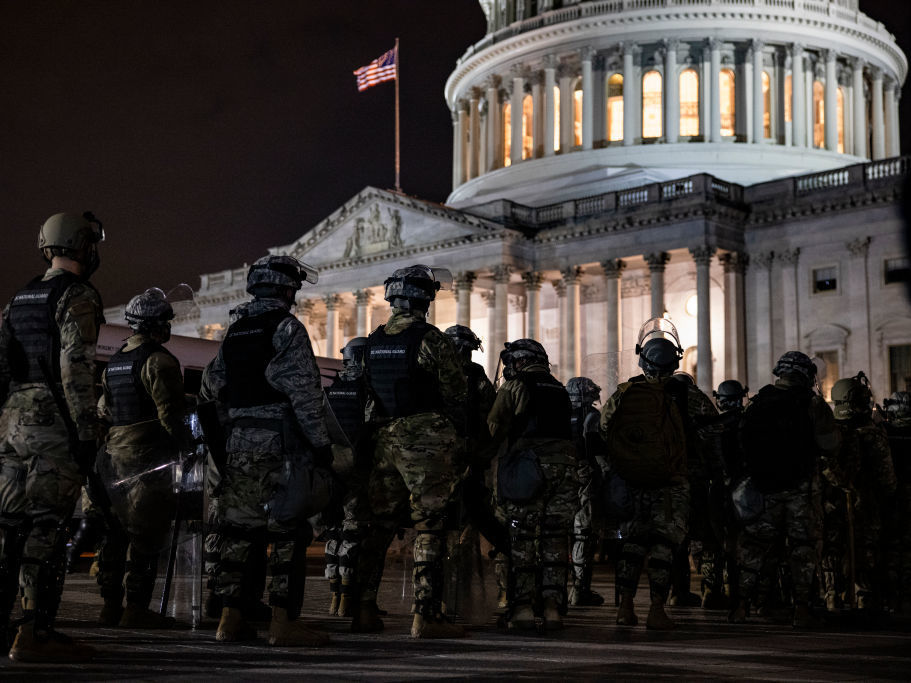 caption: Members of the National Guard and the Washington, D.C., police stand guard outside the U.S. Capitol on Jan. 6, after a pro-Trump mob stormed the complex.
