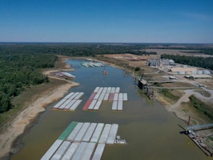 caption: Barges were stranded by low water levels along the Mississippi River in October, driving up shipping prices and threatening crop exports and fertilizer shipments. Scientists at the University of Memphis expect more dramatic swings in water levels on the river due to climate change.