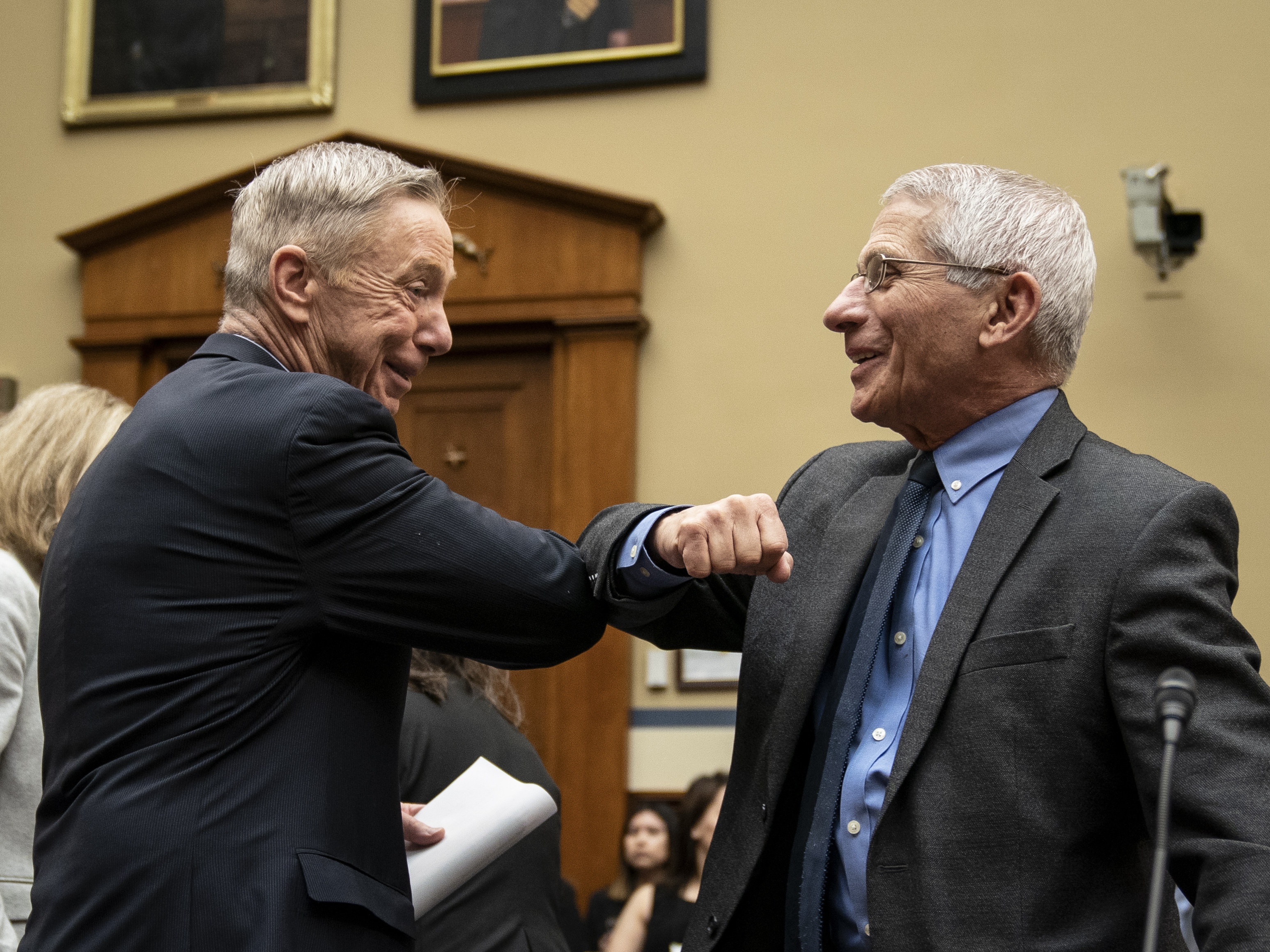 caption: Before there were masks, there were elbow bumps. Rep. Stephen Lynch, D-Mass., and Dr. Anthony Fauci greet each other before a House Oversight and Reform Committee hearing on March 11, 2020.
