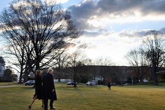 caption: President Trump and first lady Melania Trump make their way to board Marine One as they depart the White House for the last time.