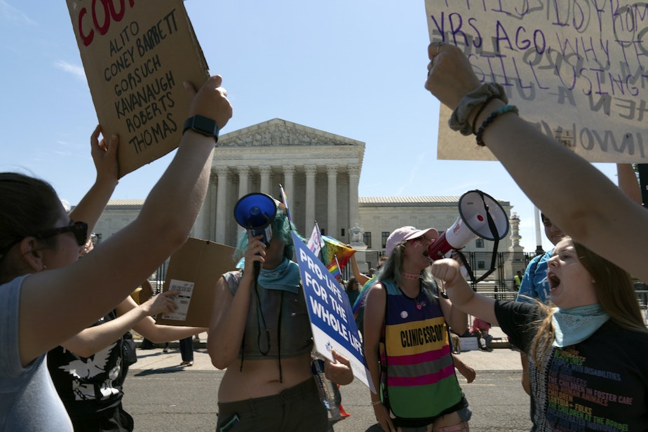 caption: Anti-abortion demonstrators and abortion right activists protest outside the Supreme Court in Washington, on June 25, 2022.