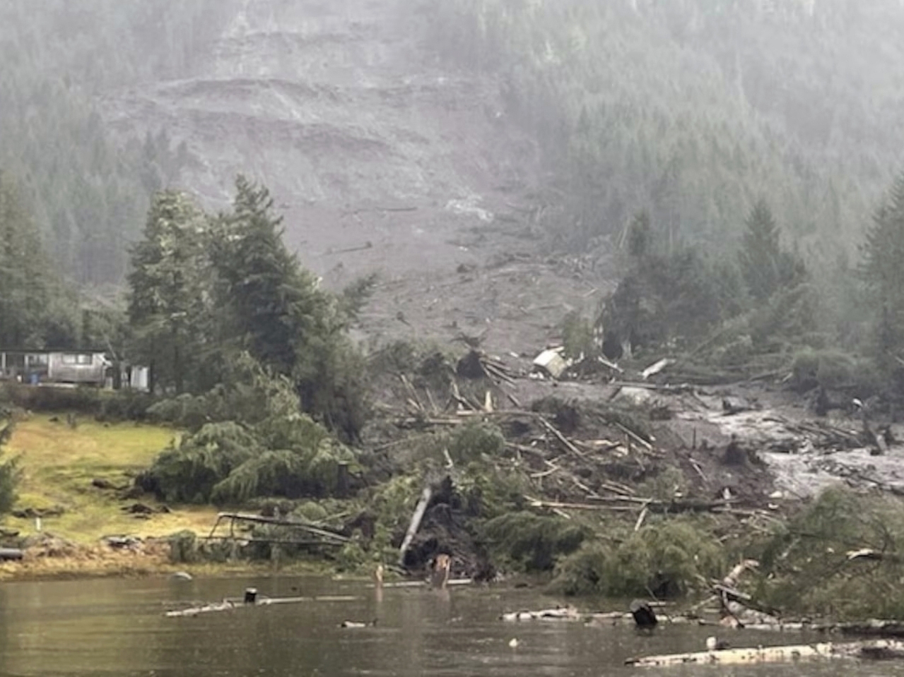 caption: This photo provided by the U.S. Coast Guard shows the aftermath of a landslide in Wrangell, Alaska in November 2023.