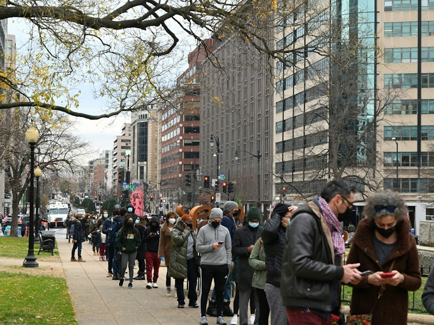 caption: People line up to get tested for COVID-19 at a testing site in Washington, D.C., on Wednesday. More than 1 million Americans tested positive for COVID-19 on Monday, according to data from Johns Hopkins University.