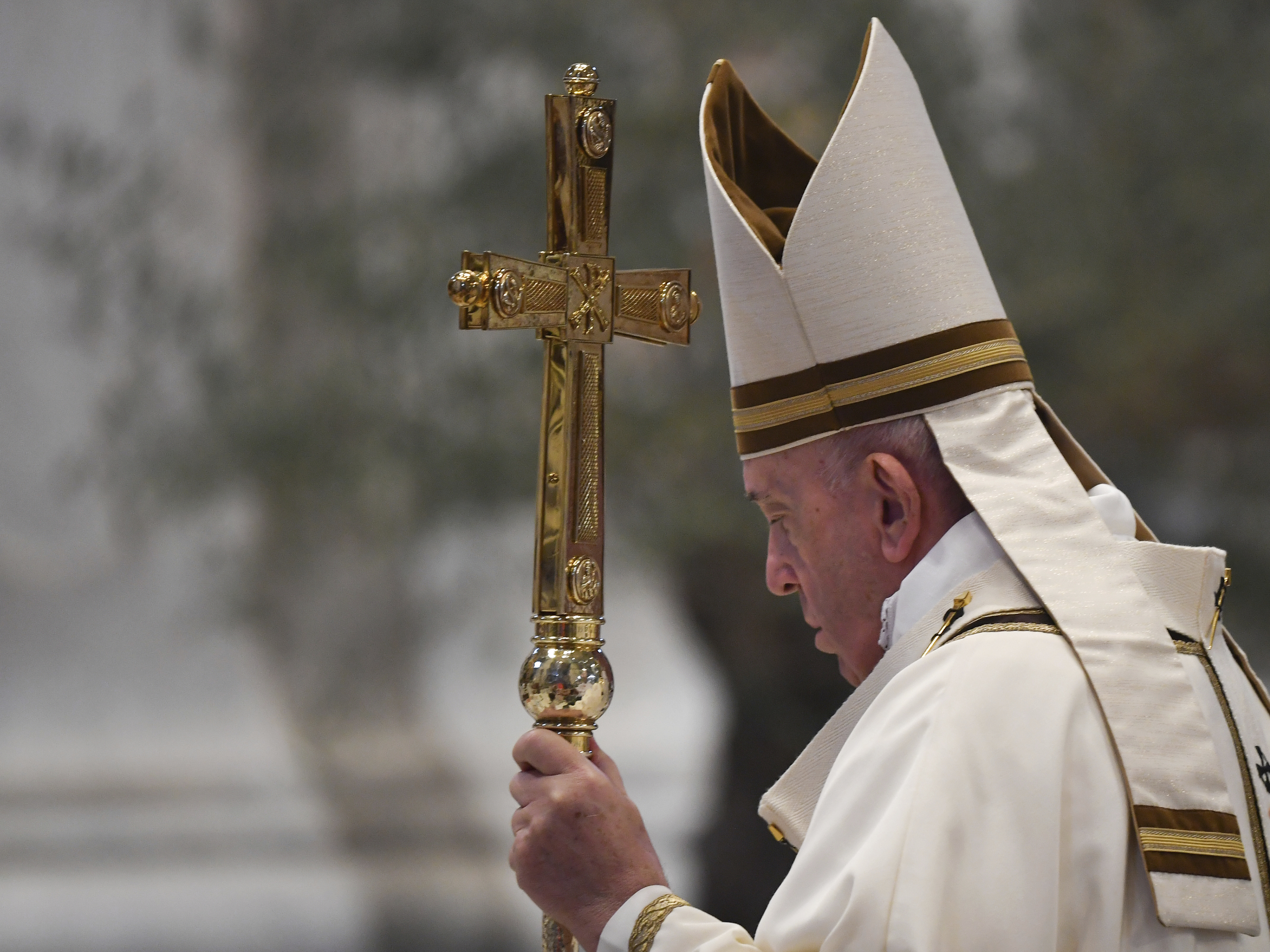 caption: Pope Francis arrives to celebrate Easter Sunday Mass, inside an empty St. Peter's Basilica at the Vatican, Sunday, April 12, 2020.