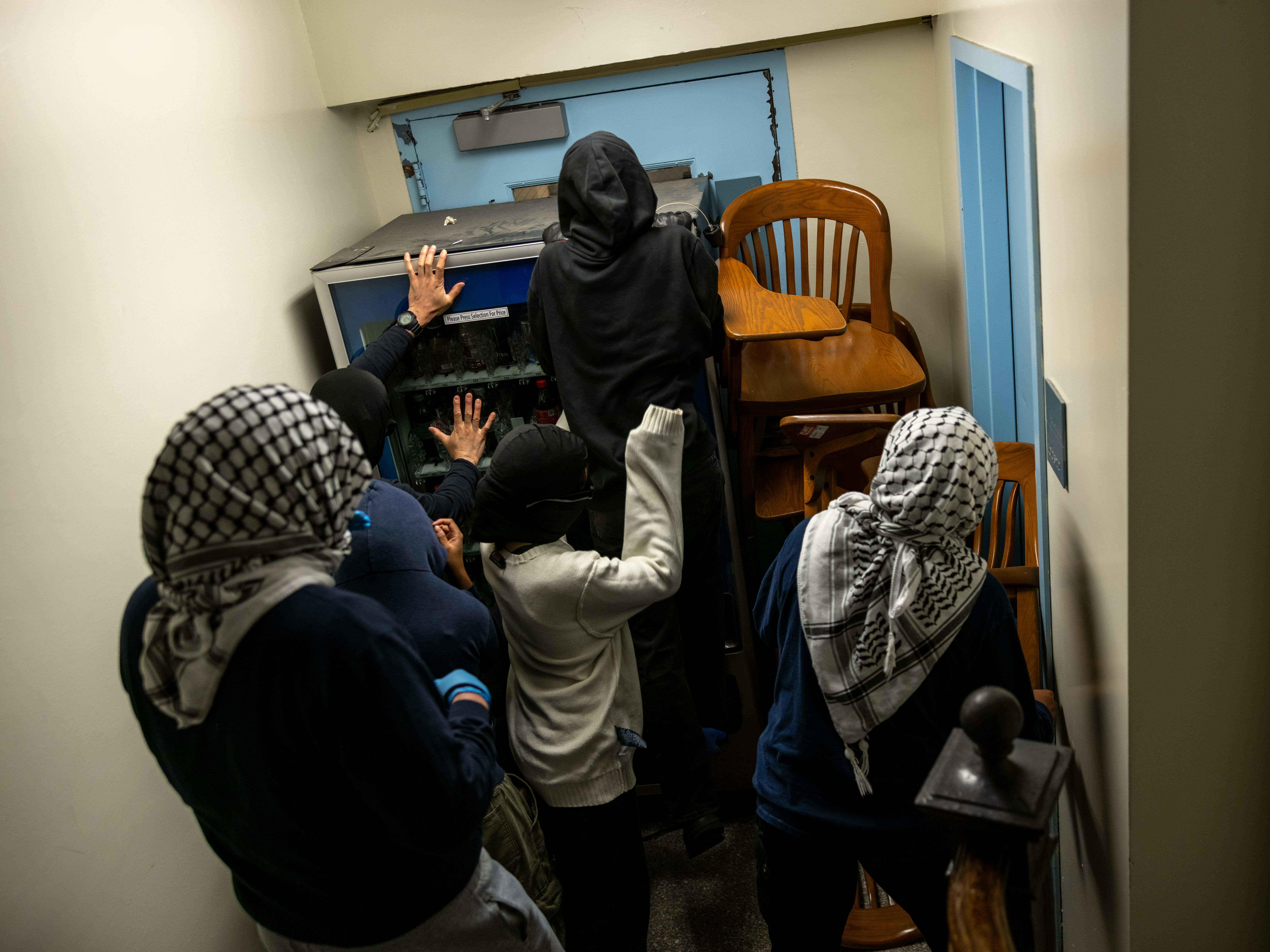 caption: Demonstrators supporting Palestinians in Gaza barricade themselves inside Hamilton Hall, where the office of the dean is located, on April 30 in New York City.
