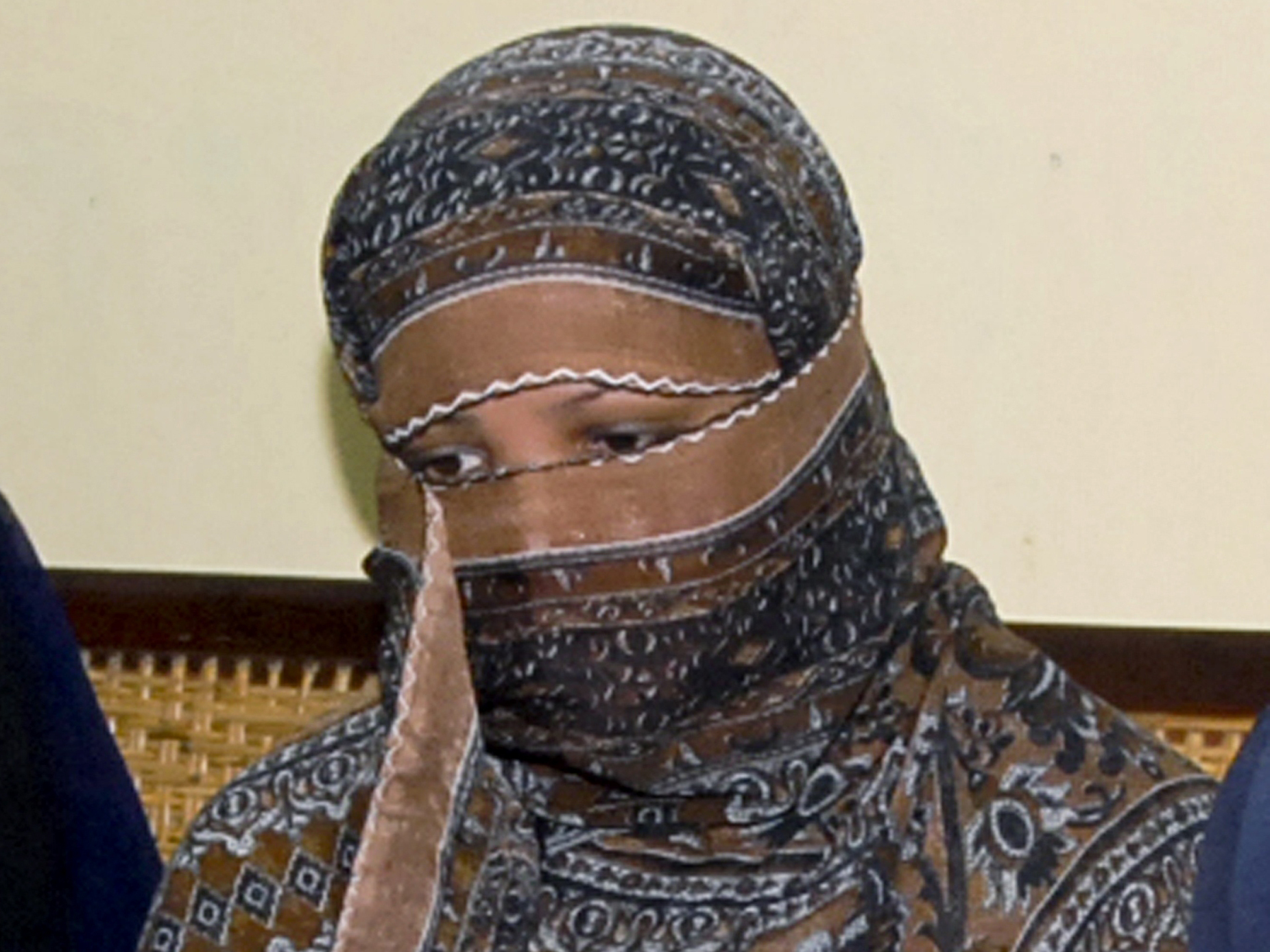 caption: Asia Bibi, a Pakistani Christian woman, listens to officials in 2010 at a prison near Lahore. Her blasphemy conviction has been reversed but advocates say she and her family are in danger in Pakistan.