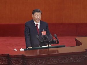 caption: Chinese President Xi Jinping delivers a speech during the opening session of the 20th National Congress of the Communist Party of China on Sunday in Beijing.