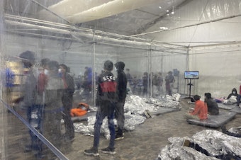 caption: Children are detained in a Customs and Border Protection temporary overflow facility in Donna, Texas on March 20. President Biden's administration faces mounting criticism for refusing to allow outside observers into facilities that are detaining thousands of migrant children.