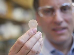 caption: Mark Prausnitz, Georgia Tech Regents professor in the School of Chemical and Biomolecular Engineering, holds a vaccine patch containing microneedles that dissolve into the skin.