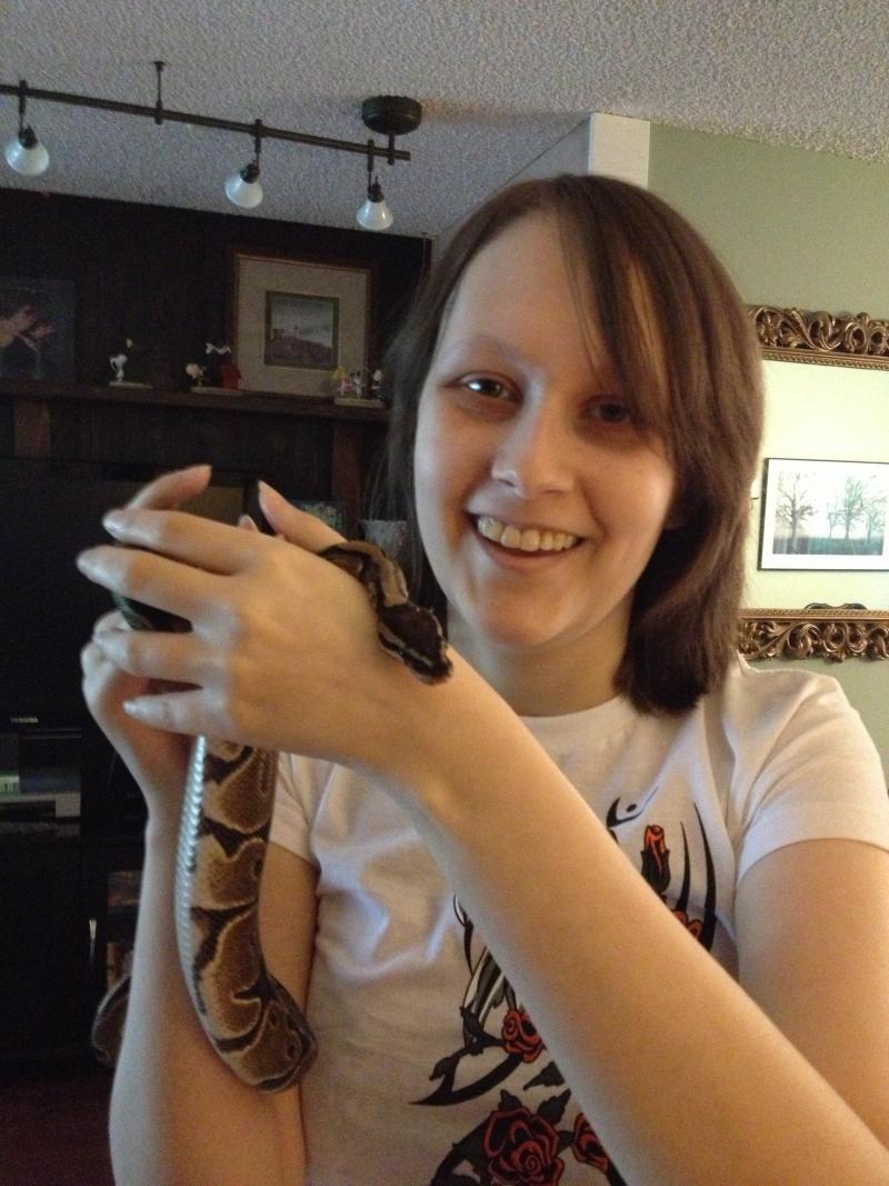 caption: Anna Stephens with her pet snake Evra. Anna's life has been on hold for the past four years since her tumor came back. She hopes to return to school again to study reptiles and amphibians.
