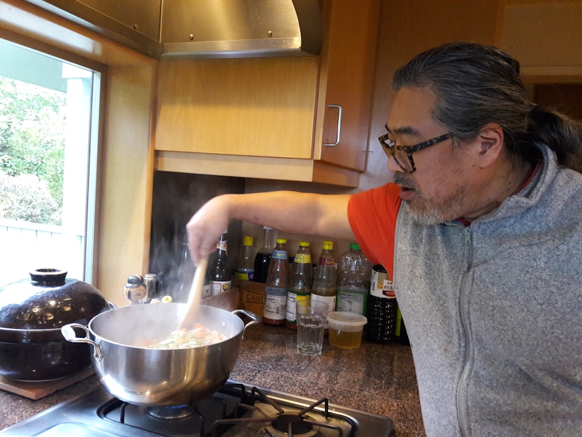 caption: Eric Tanaka at home, makes split pea soup.