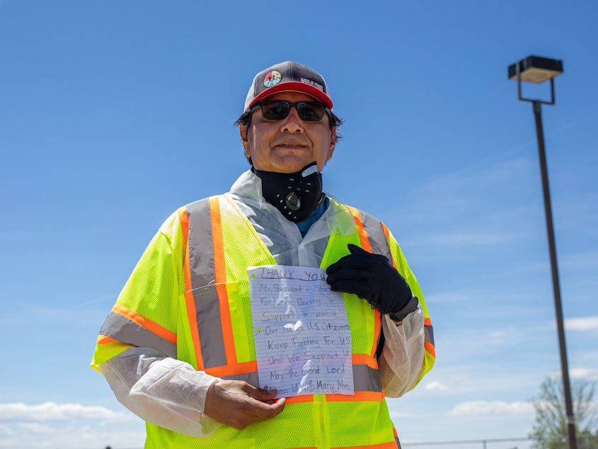 caption: Navajo Nation President Jonathan Nez holds a letter from a Navajo family while distributing food, water and other supplies on May 27, on the Navajo Nation Reservation in New Mexico.