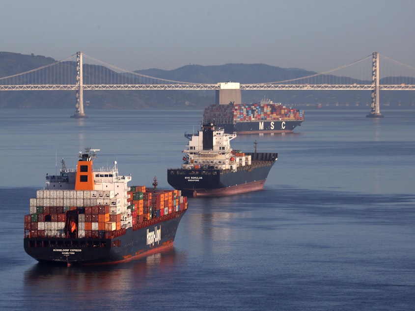 Container ships sit idle in San Francisco Bay just outside of the Port of Oakland in San Francisco in March.