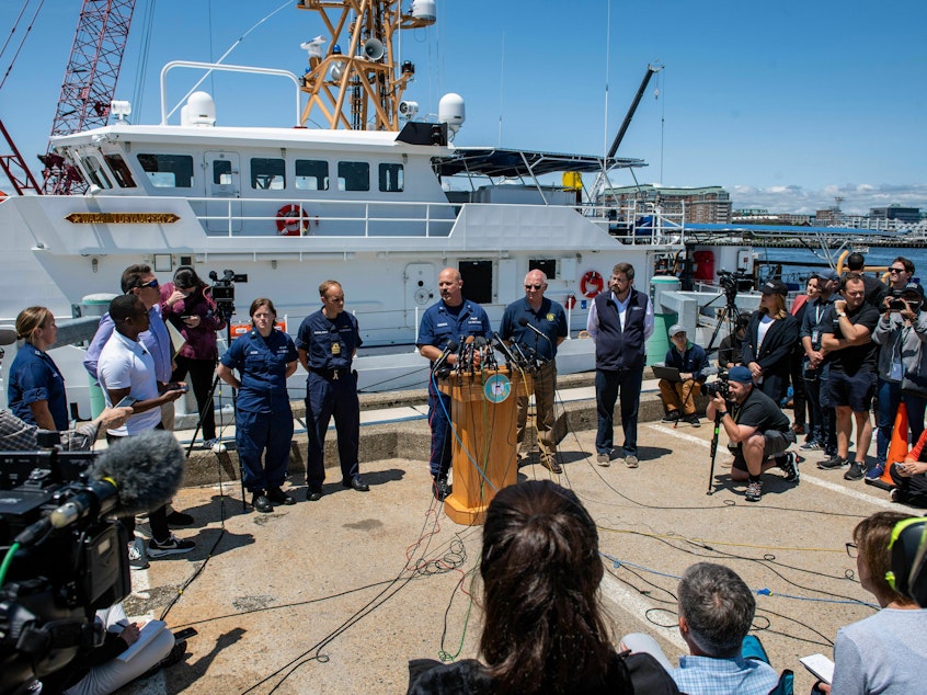 caption: U.S. Coast Guard Capt. Jamie Frederick speaks to reporters about the search for the Titan submersible on Wednesday in Boston, Mass.