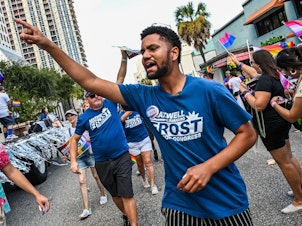 caption: Maxwell Frost marching in Orlando's Pride Parade.