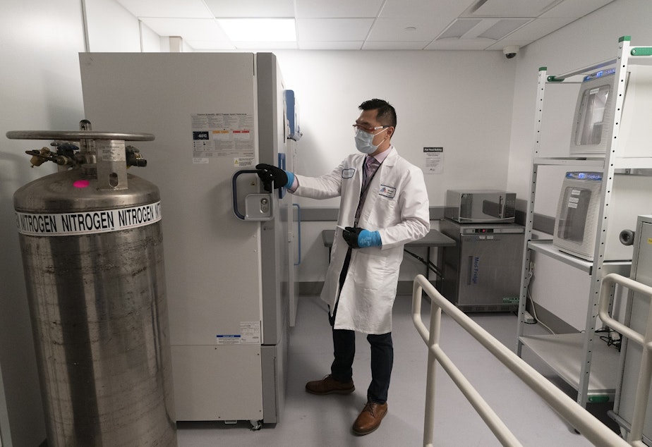 caption: Pharmacist Billy Sin shows the refrigerator which will store doses of Covid-19 vaccines, Wednesday, Dec. 9, 2020, at Mount Sinai Queens hospital in New York. Pfizer's vaccine must be kept at minus 94 degrees Fahrenheit. 
