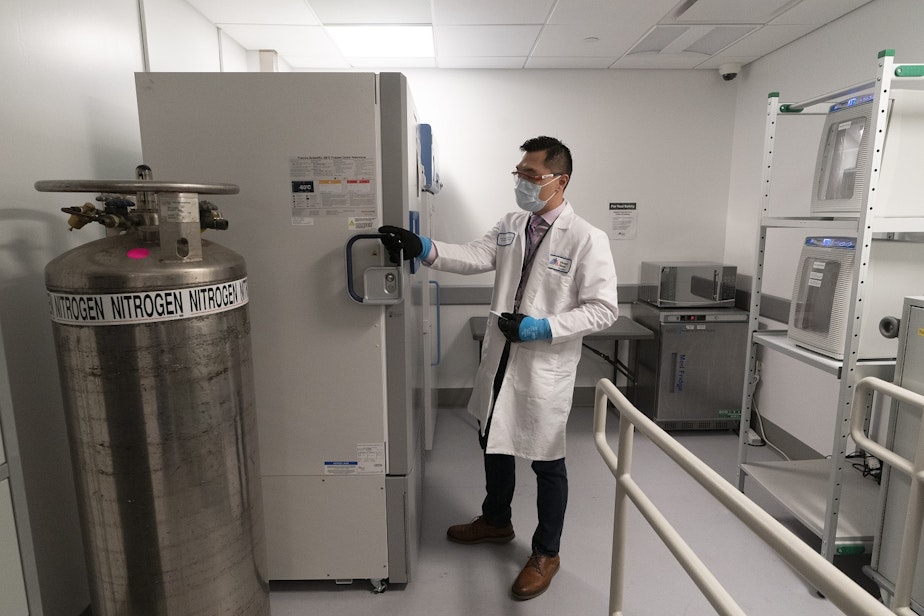 caption: Pharmacist Billy Sin shows the refrigerator which will store doses of Covid-19 vaccines, Wednesday, Dec. 9, 2020, at Mount Sinai Queens hospital in New York. Pfizer's vaccine must be kept at minus 94 degrees Fahrenheit. 