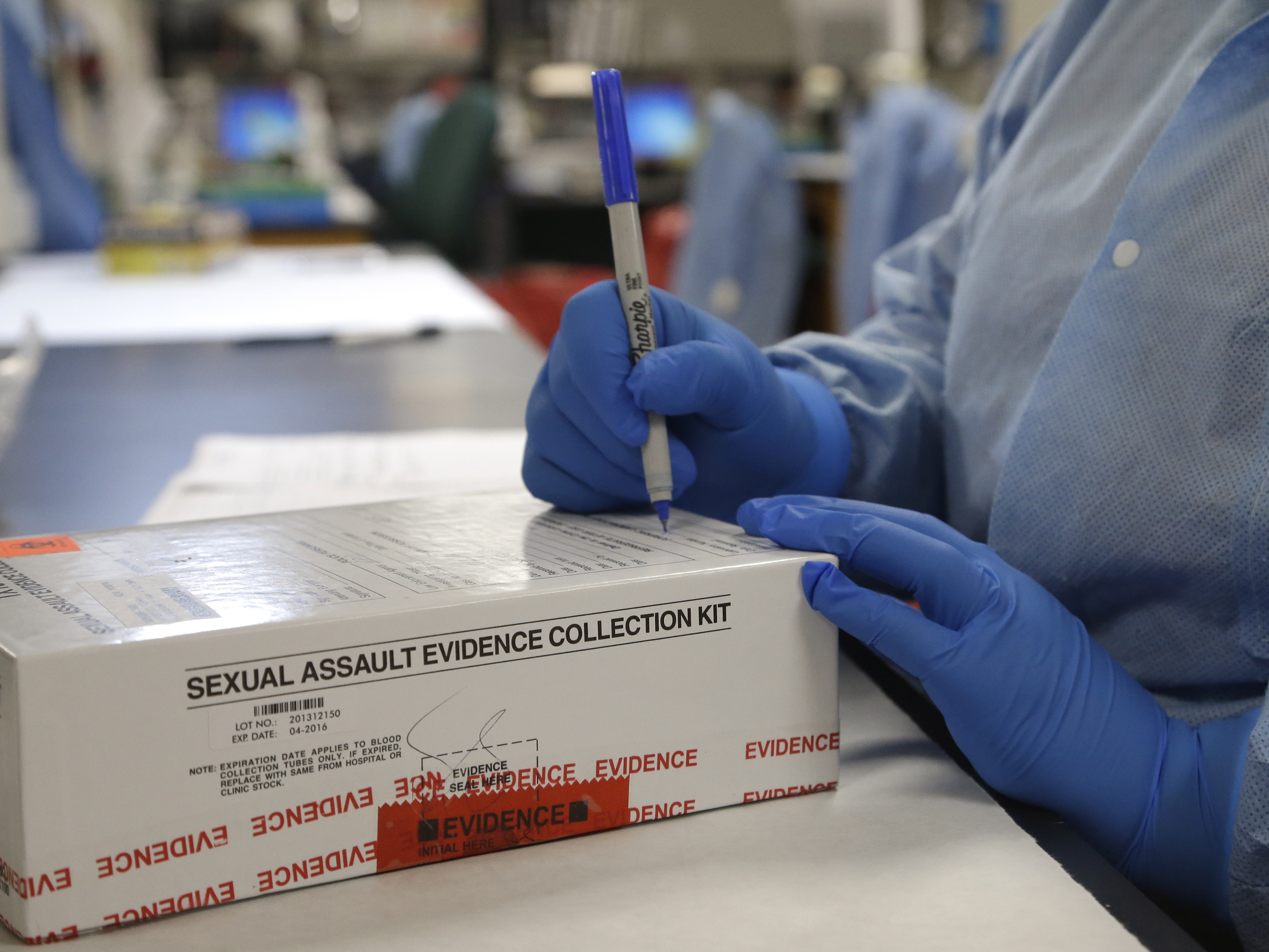 caption: A sexual assault evidence collection kit is checked in by a forensic analyst for testing in the biology lab at the Houston Forensic Science Center in 2015.