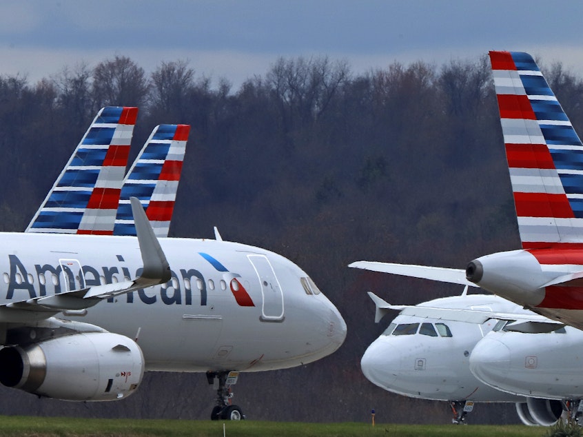 caption: American Airlines planes are shown parked at Pittsburgh International Airport on March 31, 2020, in Imperial, Pa.