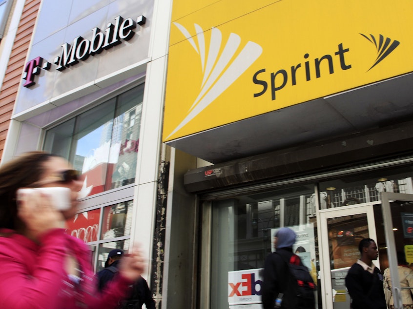 caption: FCC Chairman Ajit Pai said Monday that he endorses the merger of T-Mobile and Sprint.