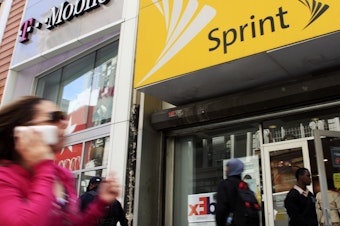 caption: FCC Chairman Ajit Pai said Monday that he endorses the merger of T-Mobile and Sprint.