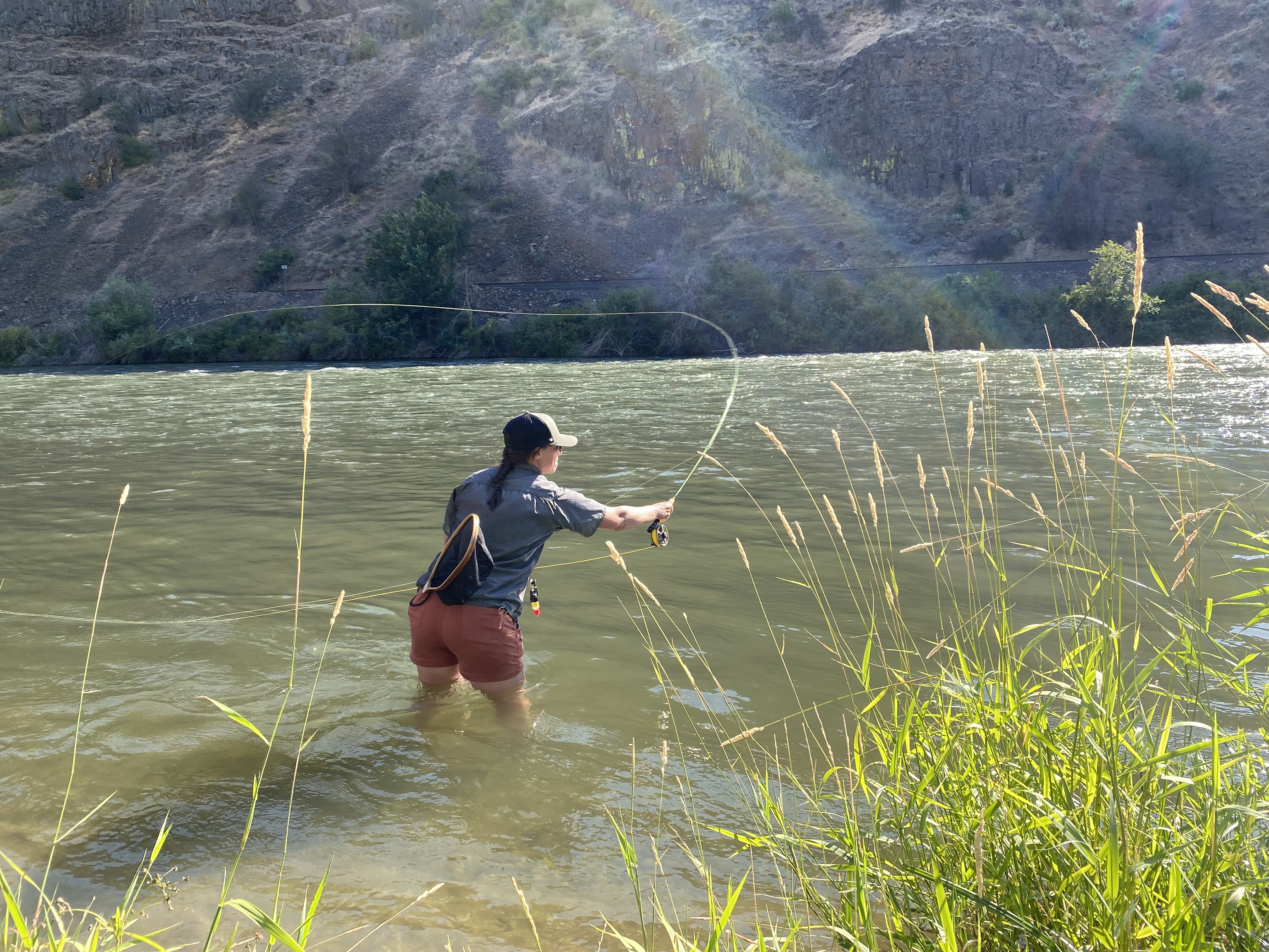 caption: Ashtyn Harris of Ellensburg fishes the Yakima River Canyon using a type of caddis dry fly. Although sometimes annoying, the caddisflies are excellent food for fish and fowl. 
