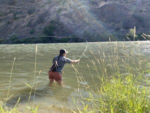 caption: Ashtyn Harris of Ellensburg fishes the Yakima River Canyon using a type of caddis dry fly. Although sometimes annoying, the caddisflies are excellent food for fish and fowl. 