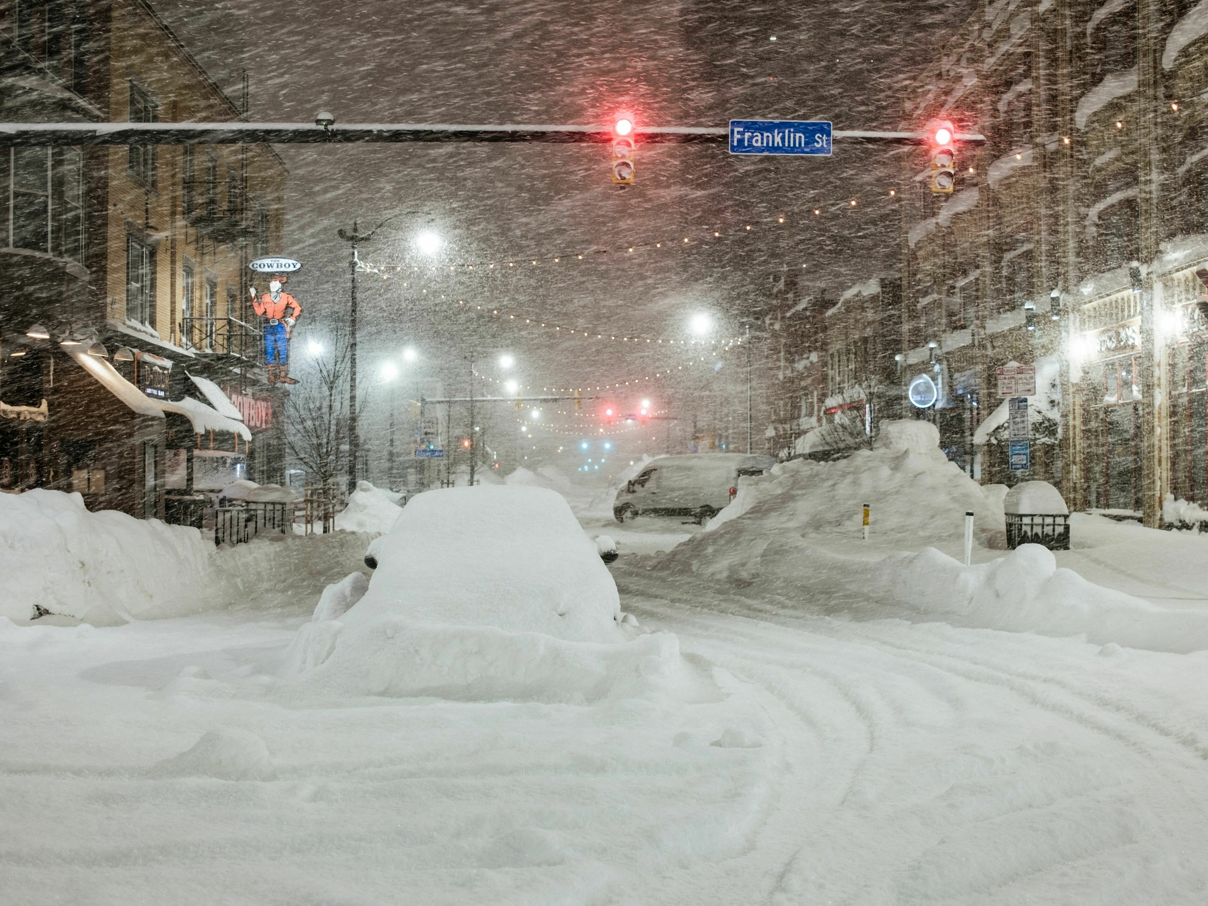 caption: Vehicles are seen abandoned in heavy snowfall in downtown Buffalo, New York, on Monday. Emergency crews counted the grim costs of a colossal winter storm that brought Christmas chaos to the U.S., especially in hard-hit western New York.