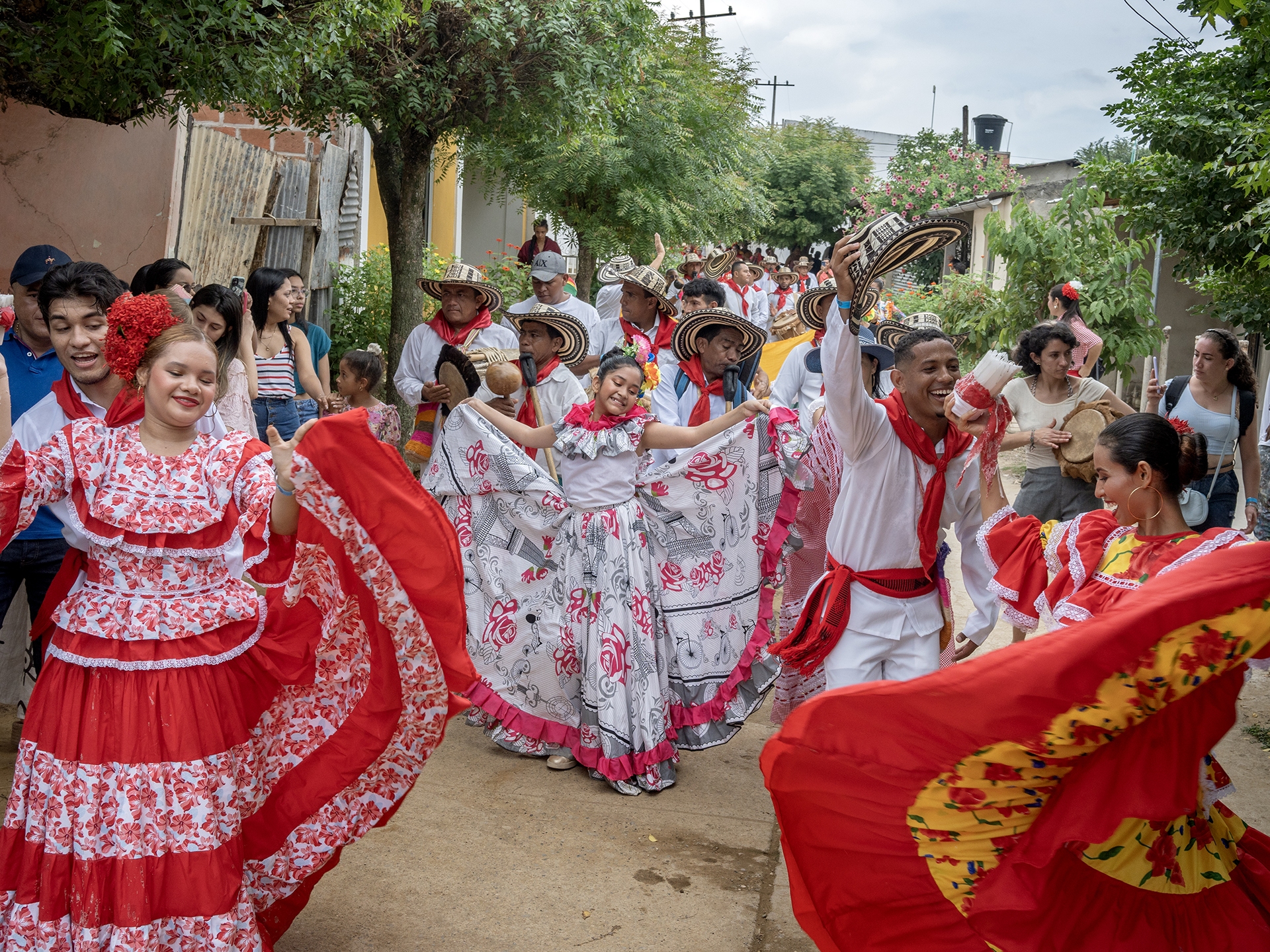 caption: Gaitero groups, dancers and the general public parade to the cemetery in San Jacinto, Colombia, on Aug. 14, 2022.